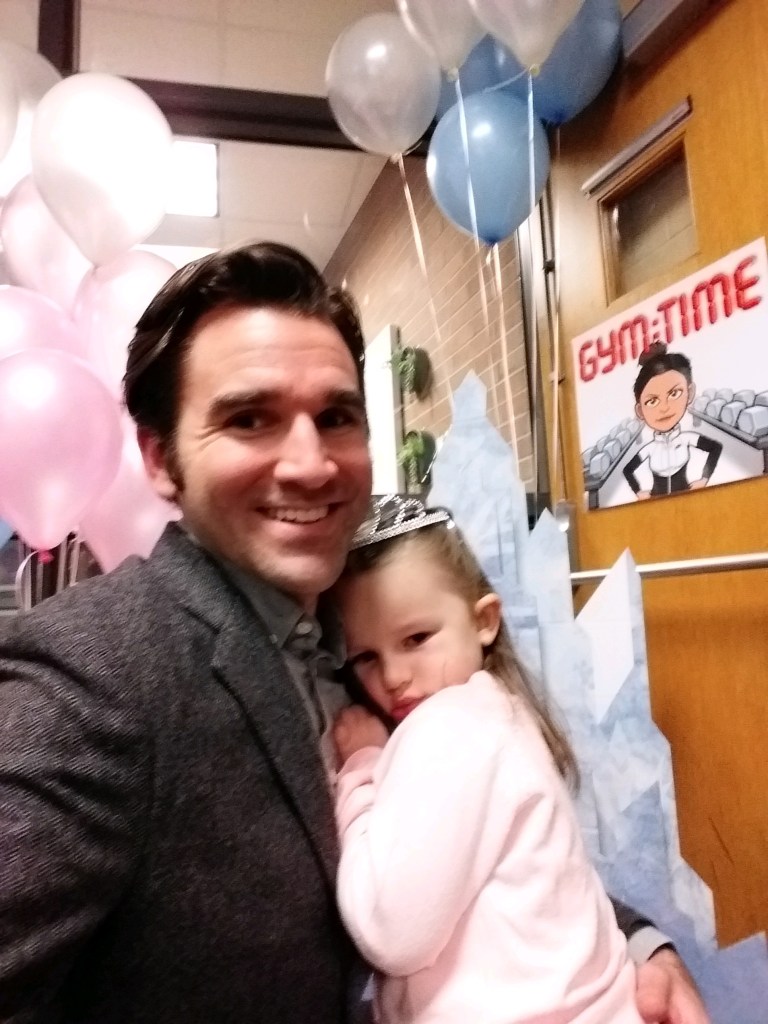 Little girl clings to Daddy.